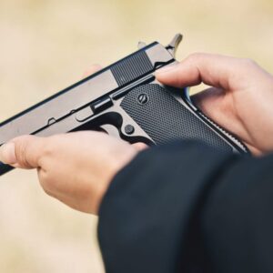 A person holding a gun in their hand